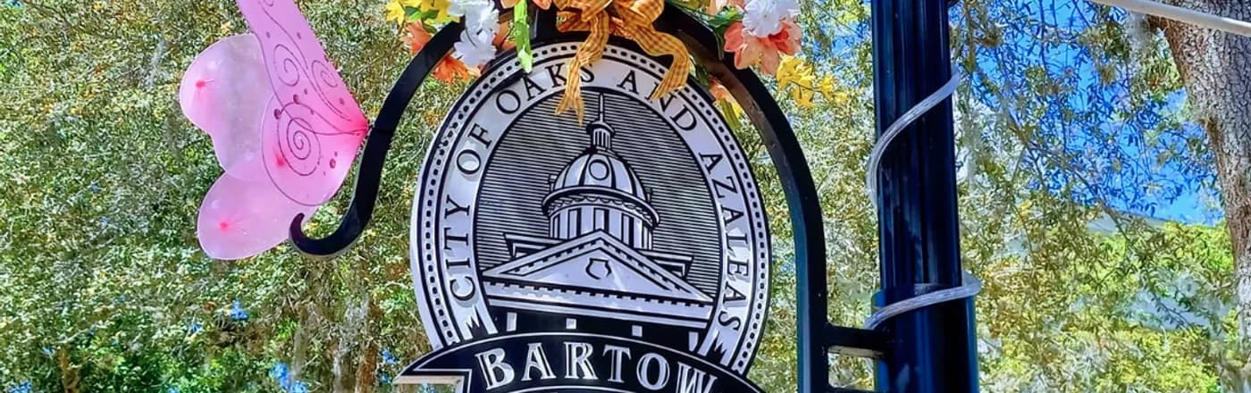 The City of Bartow seal sign beneath the live oaks