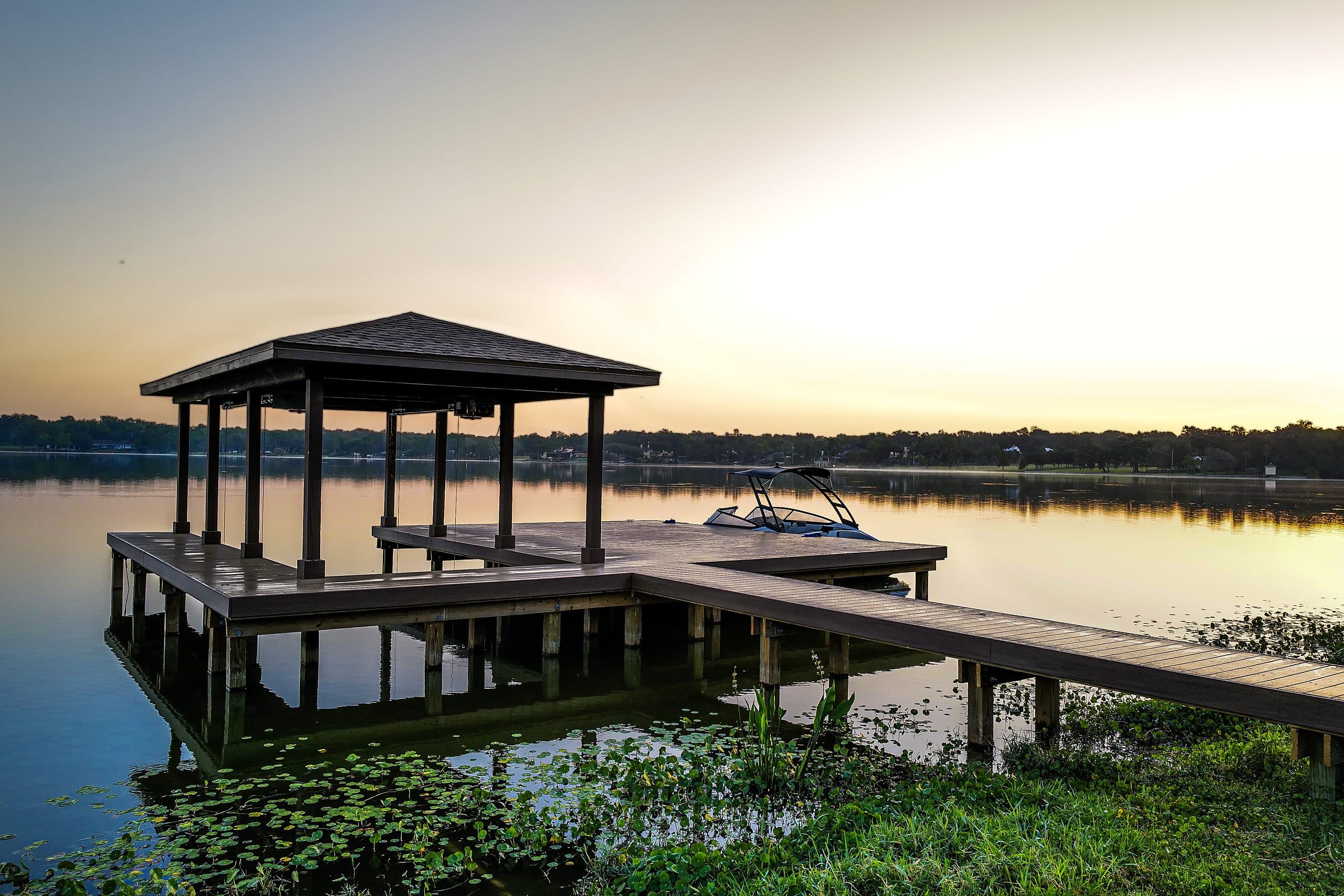 Covered boat dock at sunset on a Central Florida lake, built by Horizon Marine